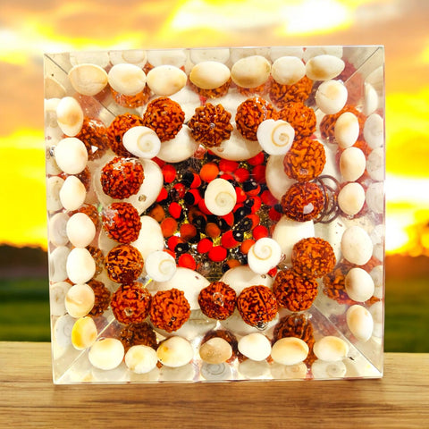 The Crystal Laxmi Pyramid With Shree Yantra, Gomti Chakra, Rudraksha, Chirmi & Kaudi Shells. The Crystal Laxmi Pyramid With Shree Yantra, Gomti Chakra, Rudraksha, Chirmi & Kaudi Shells.