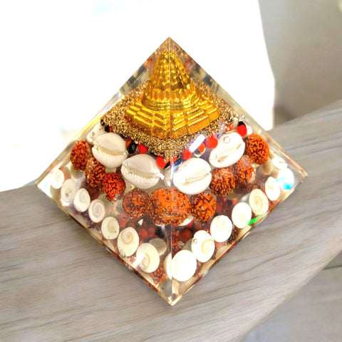 The Crystal Laxmi Pyramid With Shree Yantra, Gomti Chakra, Rudraksha, Chirmi & Kaudi Shells.