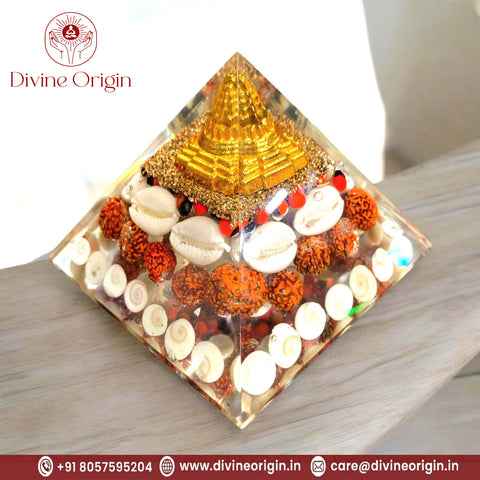 The Crystal Laxmi Pyramid With Shree Yantra, Gomti Chakra, Rudraksha, Chirmi & Kaudi Shells.