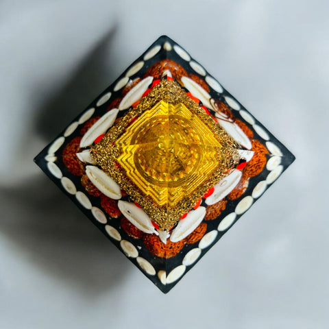 The Crystal Laxmi Pyramid With Shree Yantra, Gomti Chakra, Rudraksha, Chirmi & Kaudi Shells.