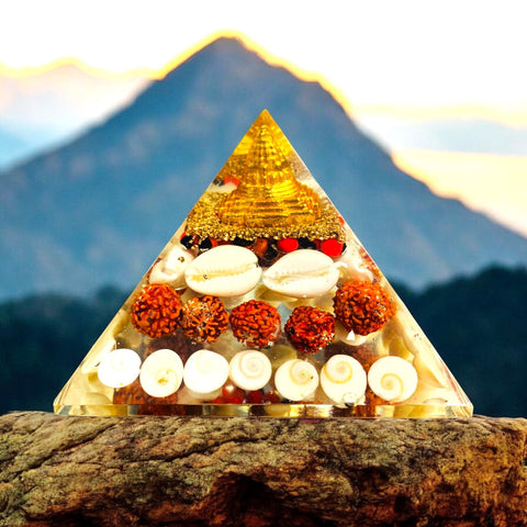 The Crystal Laxmi Pyramid With Shree Yantra, Gomti Chakra, Rudraksha, Chirmi & Kaudi Shells.