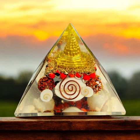 The Crystal Laxmi Pyramid With Shree Yantra, Gomti Chakra, Rudraksha, Chirmi & Kaudi Shells.