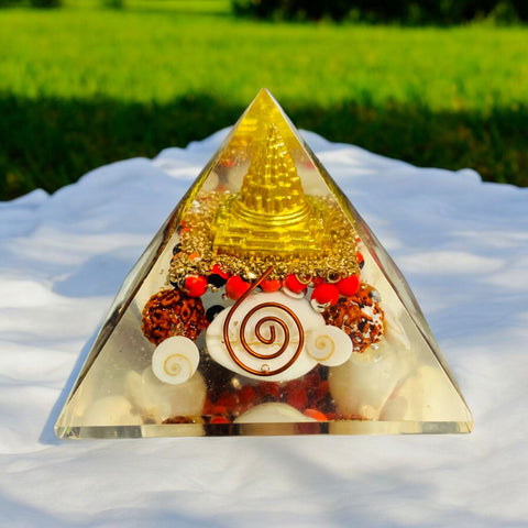 The Crystal Laxmi Pyramid With Shree Yantra, Gomti Chakra, Rudraksha, Chirmi & Kaudi Shells.