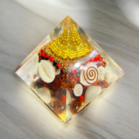 The Crystal Laxmi Pyramid With Shree Yantra, Gomti Chakra, Rudraksha, Chirmi & Kaudi Shells.