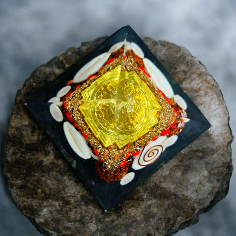 The Crystal Laxmi Pyramid With Shree Yantra, Gomti Chakra, Rudraksha, Chirmi & Kaudi Shells.